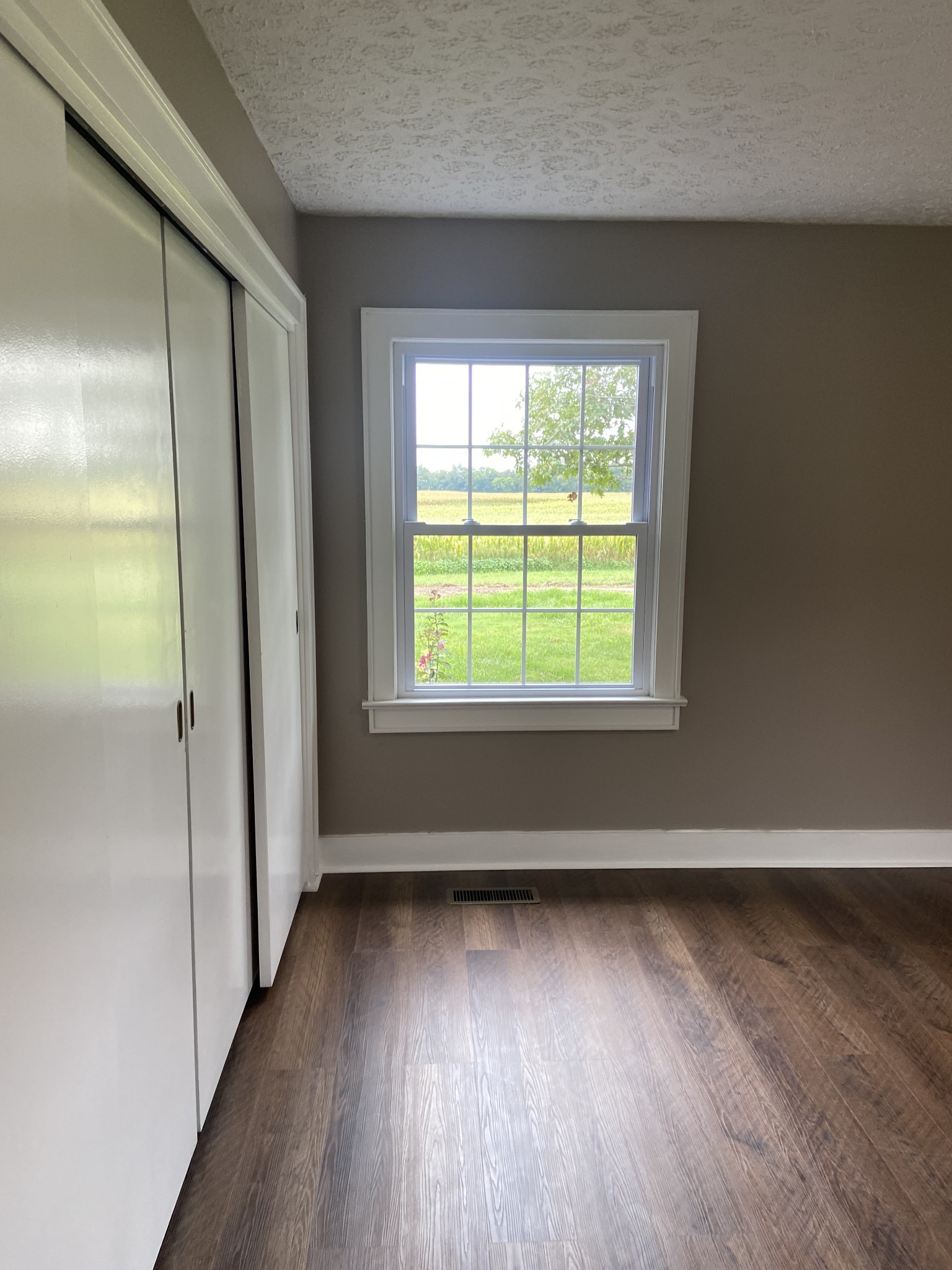 11495 Guthrie Road Guthrie, KY 42234 - Photo 29 of 43 an empty room with wooden floor and windows