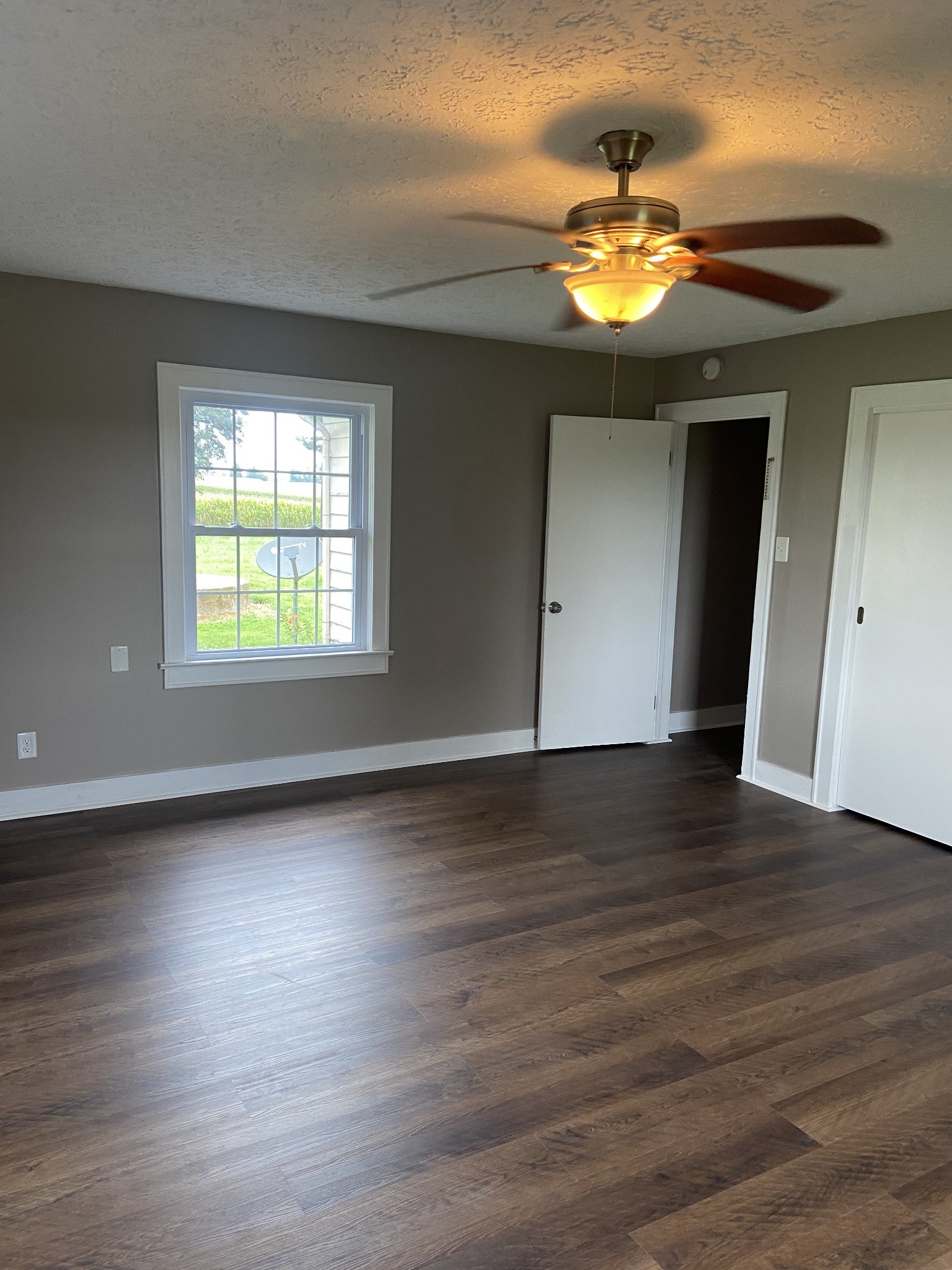 11495 Guthrie Road Guthrie, KY 42234 - Photo 37 of 43 a view of an empty room with wooden floor and a window