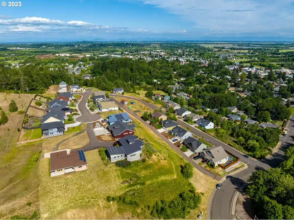 an aerial view of a house with a swimming pool yard and mountain view