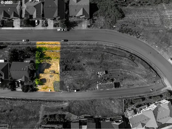 an aerial view of a swimming pool with outdoor seating and yard