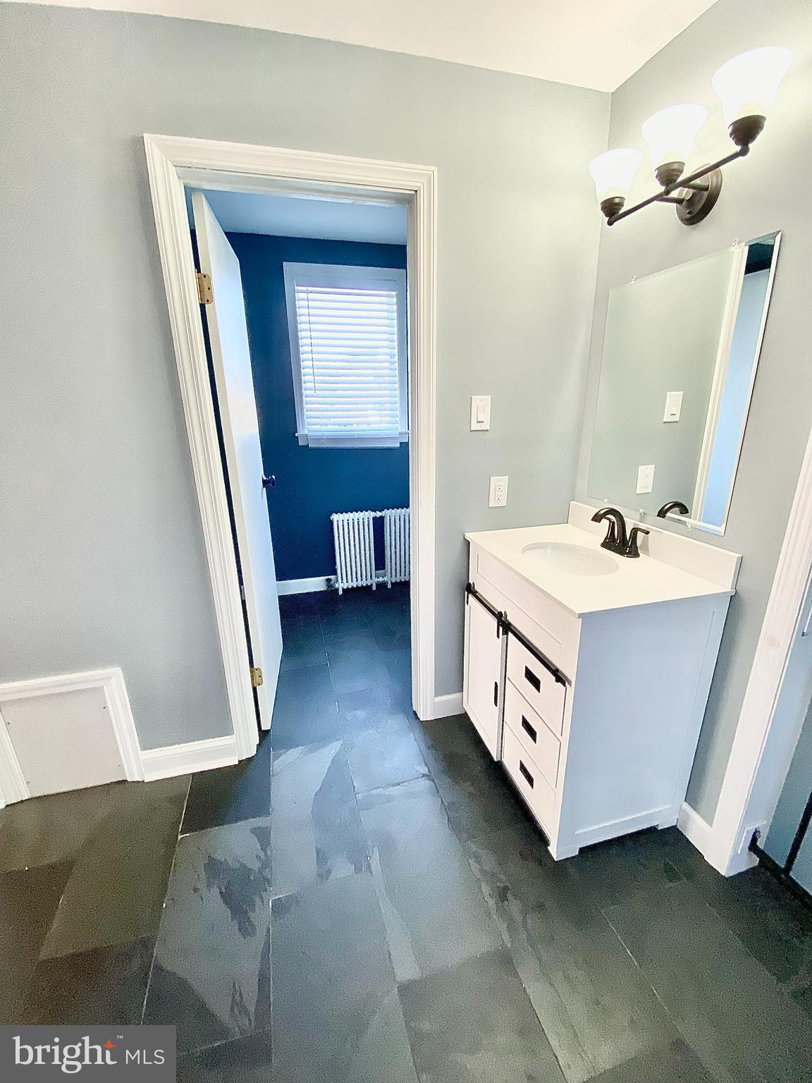 67 Main Street, Unit A Mantua, NJ 08051 - Photo 8 of 13 a bathroom with a sink and a mirror