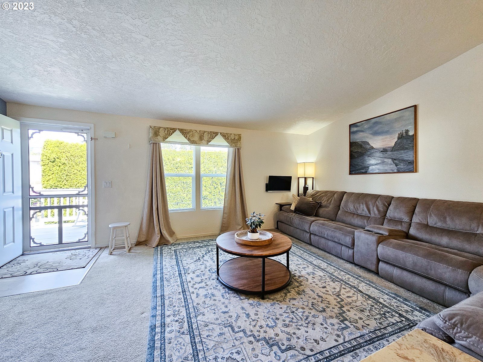 12450 Southwest Fischer Road, Unit 142 Tigard, OR 97224 - Photo 12 of 35 a living room with furniture and a large window