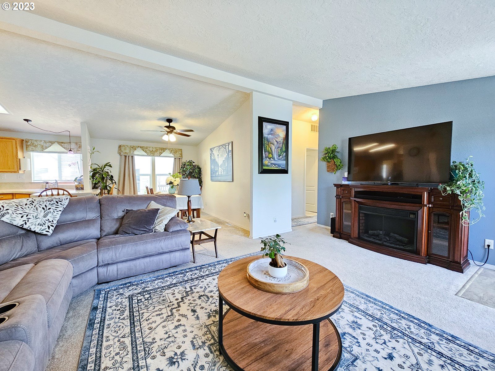 12450 Southwest Fischer Road, Unit 142 Tigard, OR 97224 - Photo 14 of 35 a living room with furniture and a flat screen tv