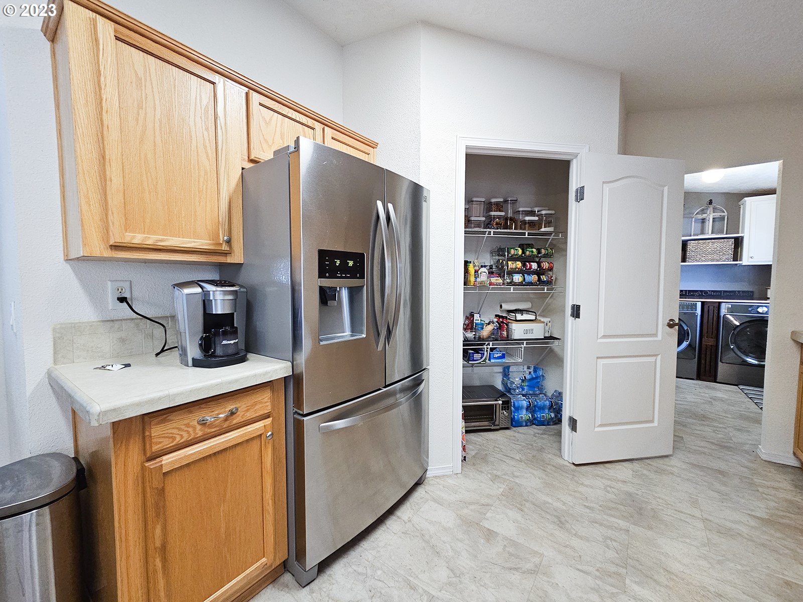 12450 Southwest Fischer Road, Unit 142 Tigard, OR 97224 - Photo 19 of 35 a kitchen with stainless steel appliances a refrigerator sink and cabinets