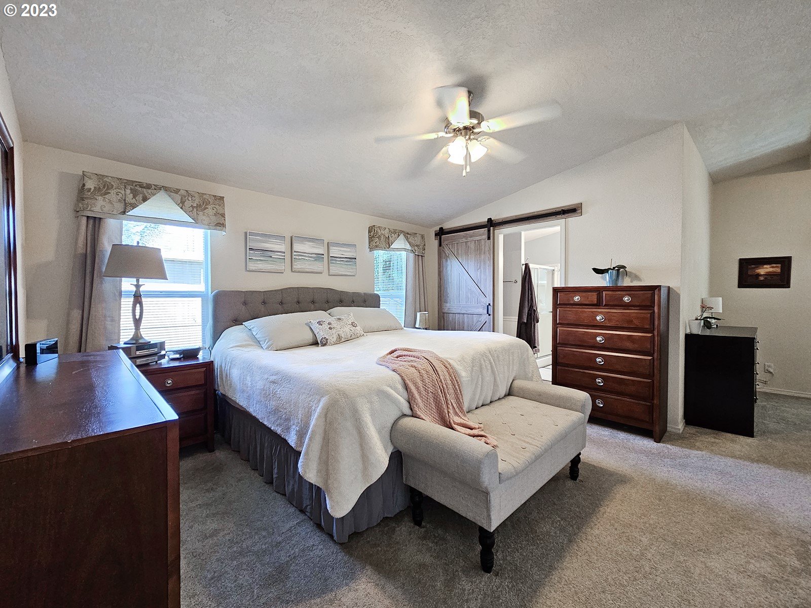 12450 Southwest Fischer Road, Unit 142 Tigard, OR 97224 - Photo 21 of 35 a spacious bedroom with a bed and a desk