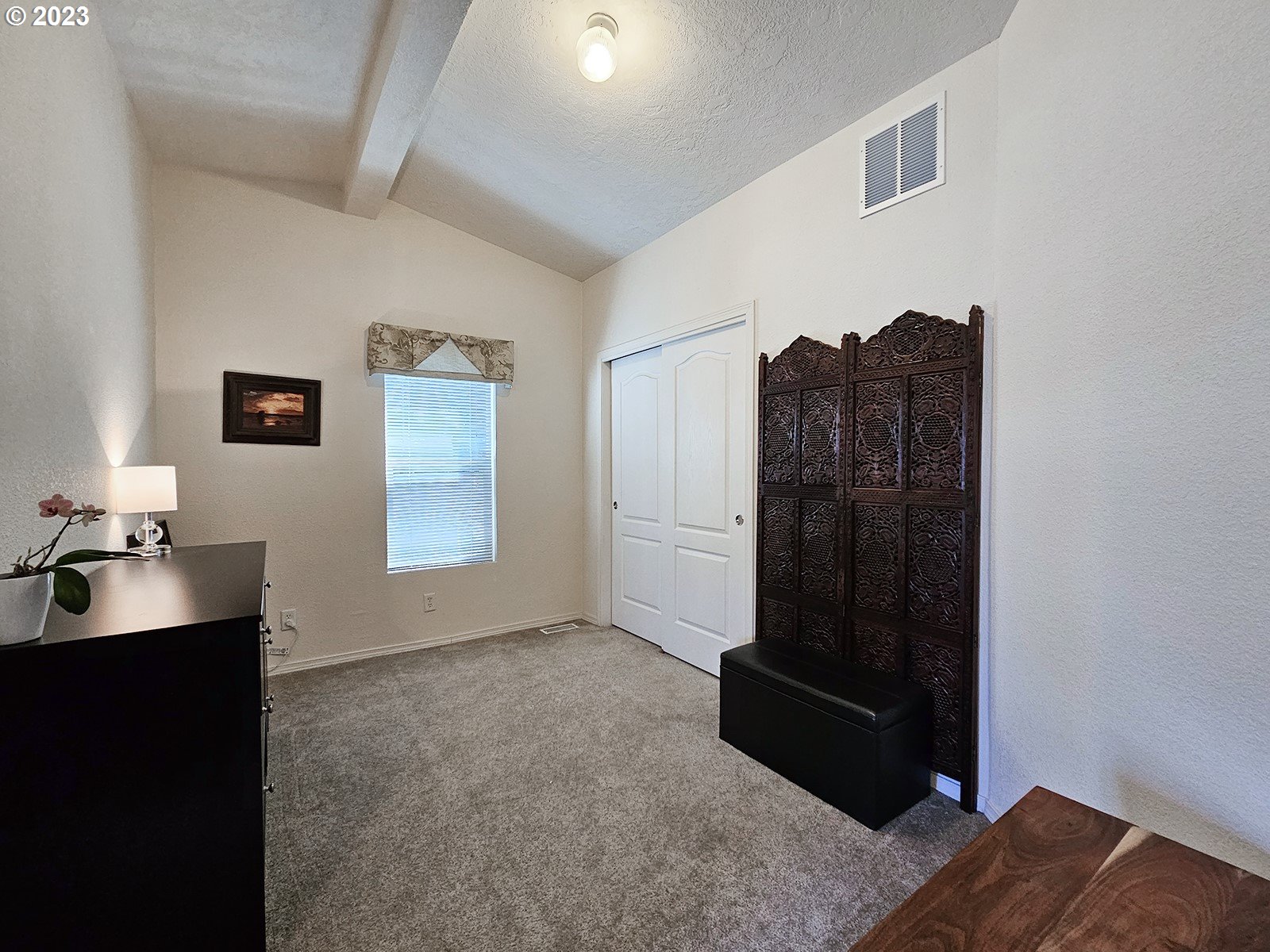 12450 Southwest Fischer Road, Unit 142 Tigard, OR 97224 - Photo 25 of 35 a room with a bed and a dresser