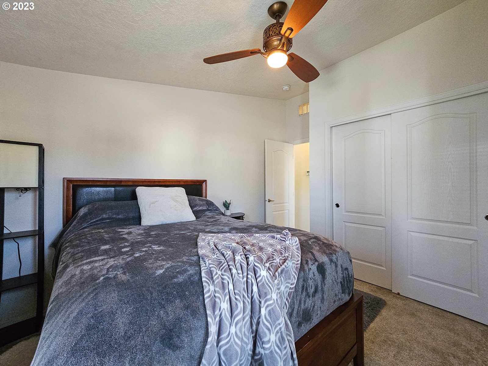 12450 Southwest Fischer Road, Unit 142 Tigard, OR 97224 - Photo 29 of 35 a bedroom with a bed and a chandelier