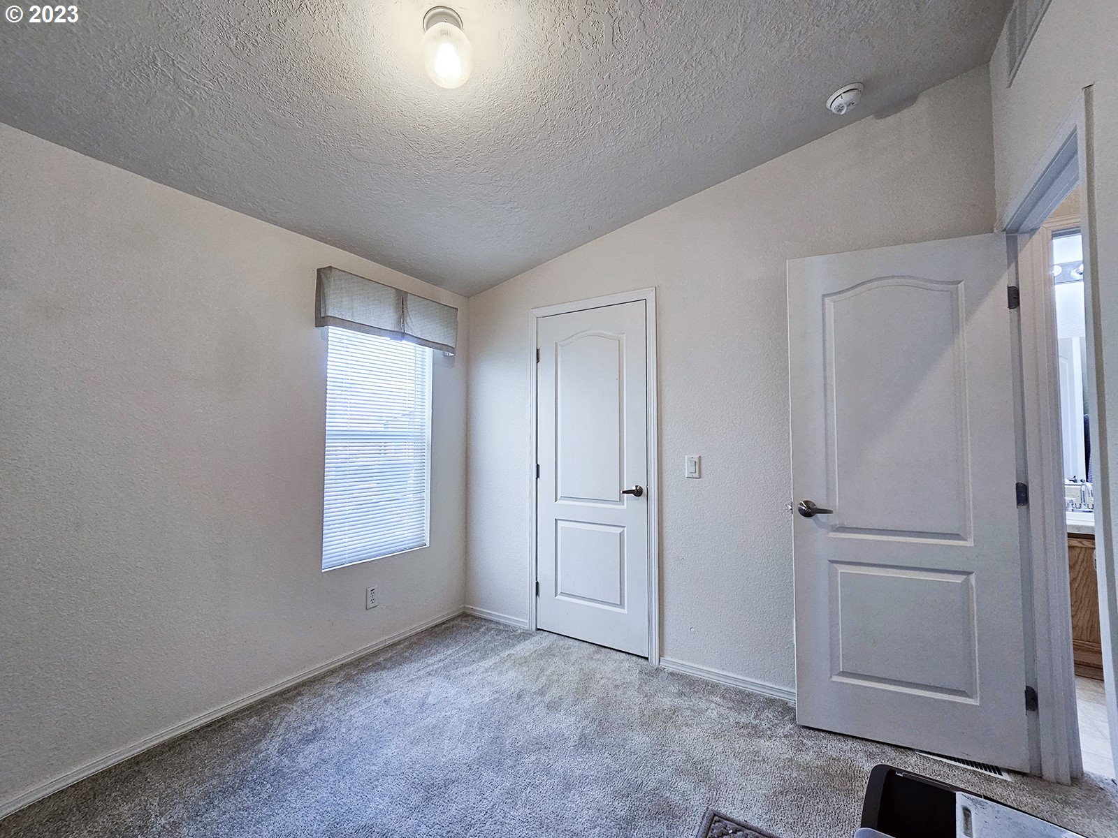 12450 Southwest Fischer Road, Unit 142 Tigard, OR 97224 - Photo 31 of 35 an empty room with windows and closet