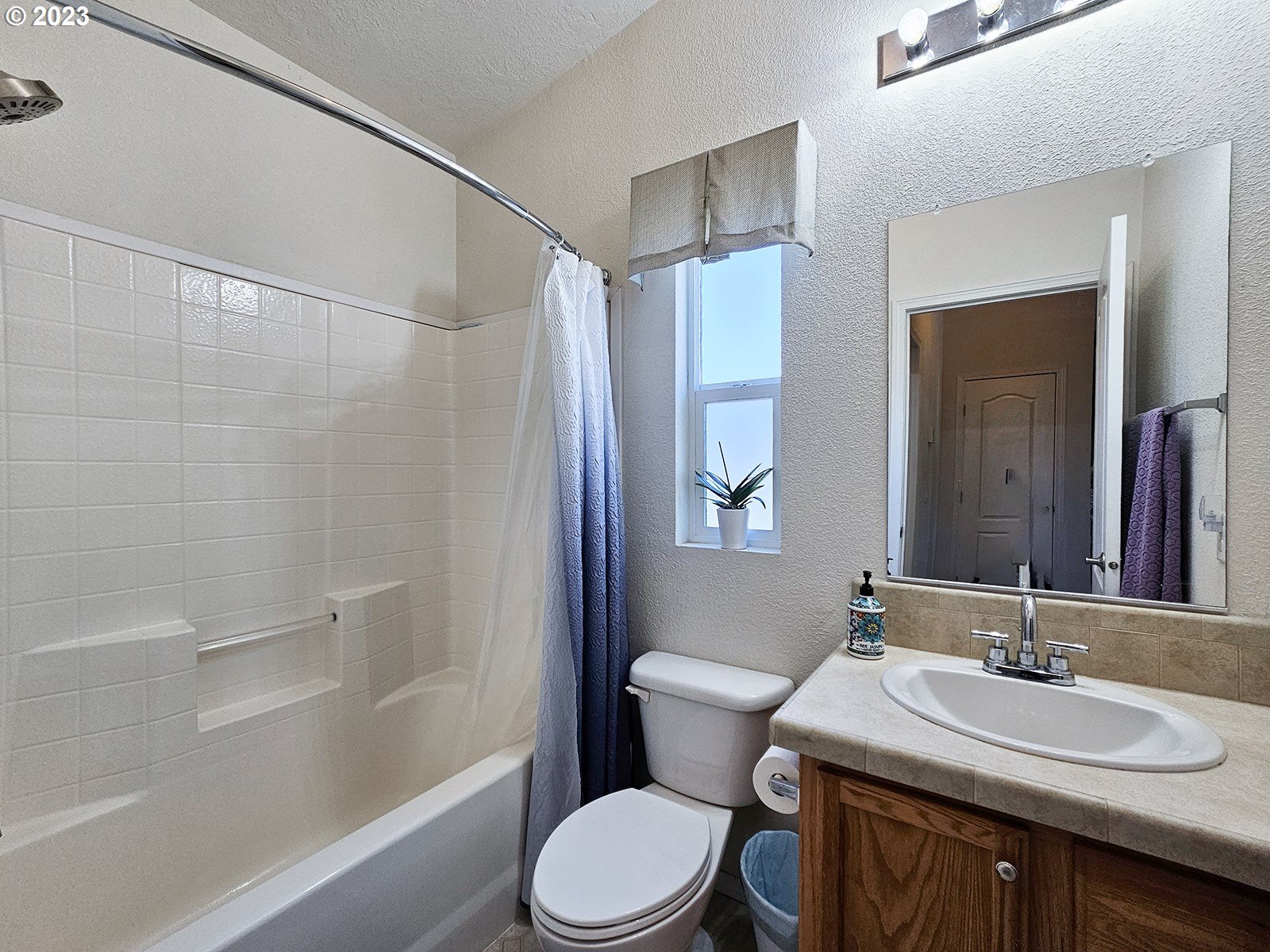 12450 Southwest Fischer Road, Unit 142 Tigard, OR 97224 - Photo 32 of 35 a bathroom with a sink toilet vanity and shower
