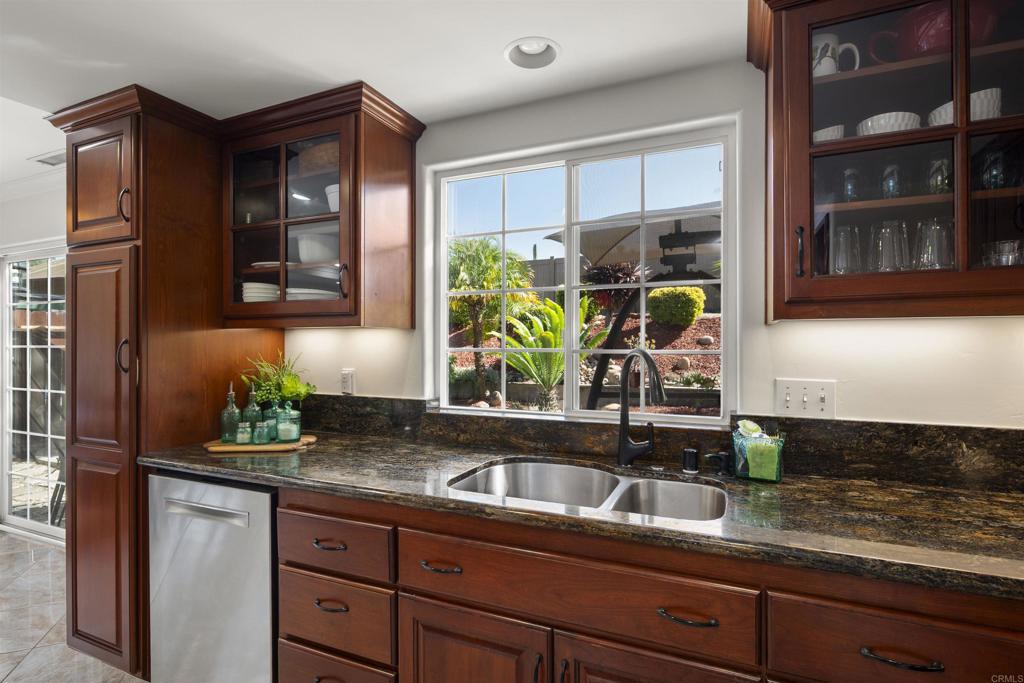4627 Huggins Street University City, CA 92122 - Photo 16 of 54 a kitchen with stainless steel appliances granite countertop a sink and a window