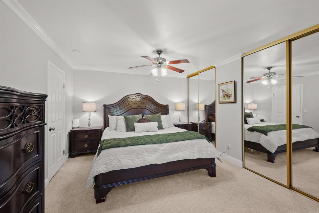 4627 Huggins Street University City, CA 92122 - Photo 24 of 54 a bedroom with a bed and a chandelier