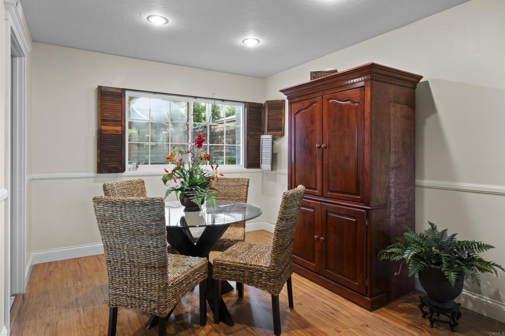 4627 Huggins Street University City, CA 92122 - Photo 4 of 54 a dining room with furniture potted plants and wooden floor
