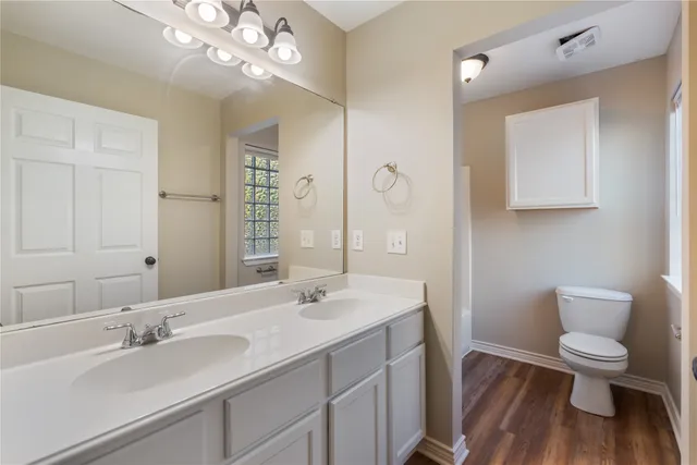 a white toilet sitting next to a bath tub