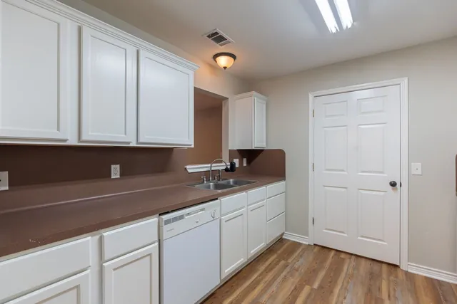 a kitchen with a sink stove and cabinets