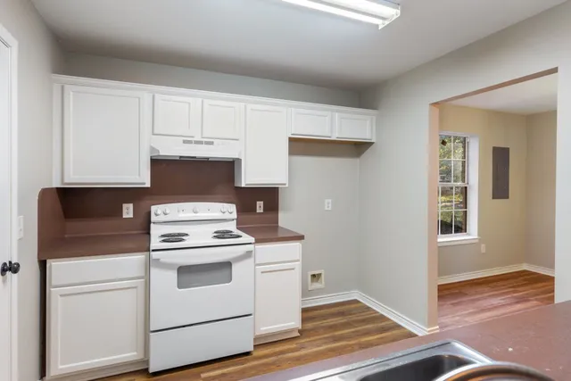 a view of a room with wooden floor