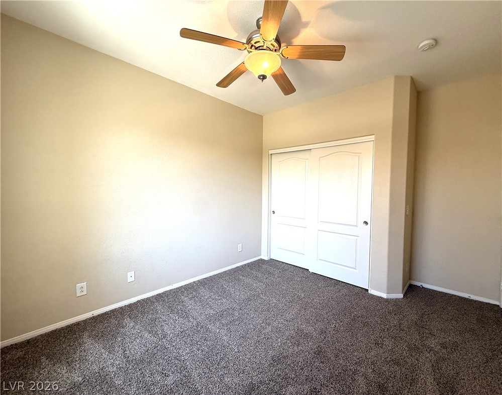 5942 Rampolla Drive Las Vegas, NV 89141 - Photo 21 of 27 Comfortable bedroom with neutral walls and soft carpeting, perfect for peaceful rest.