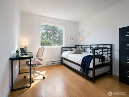 a bedroom with a bed and a window