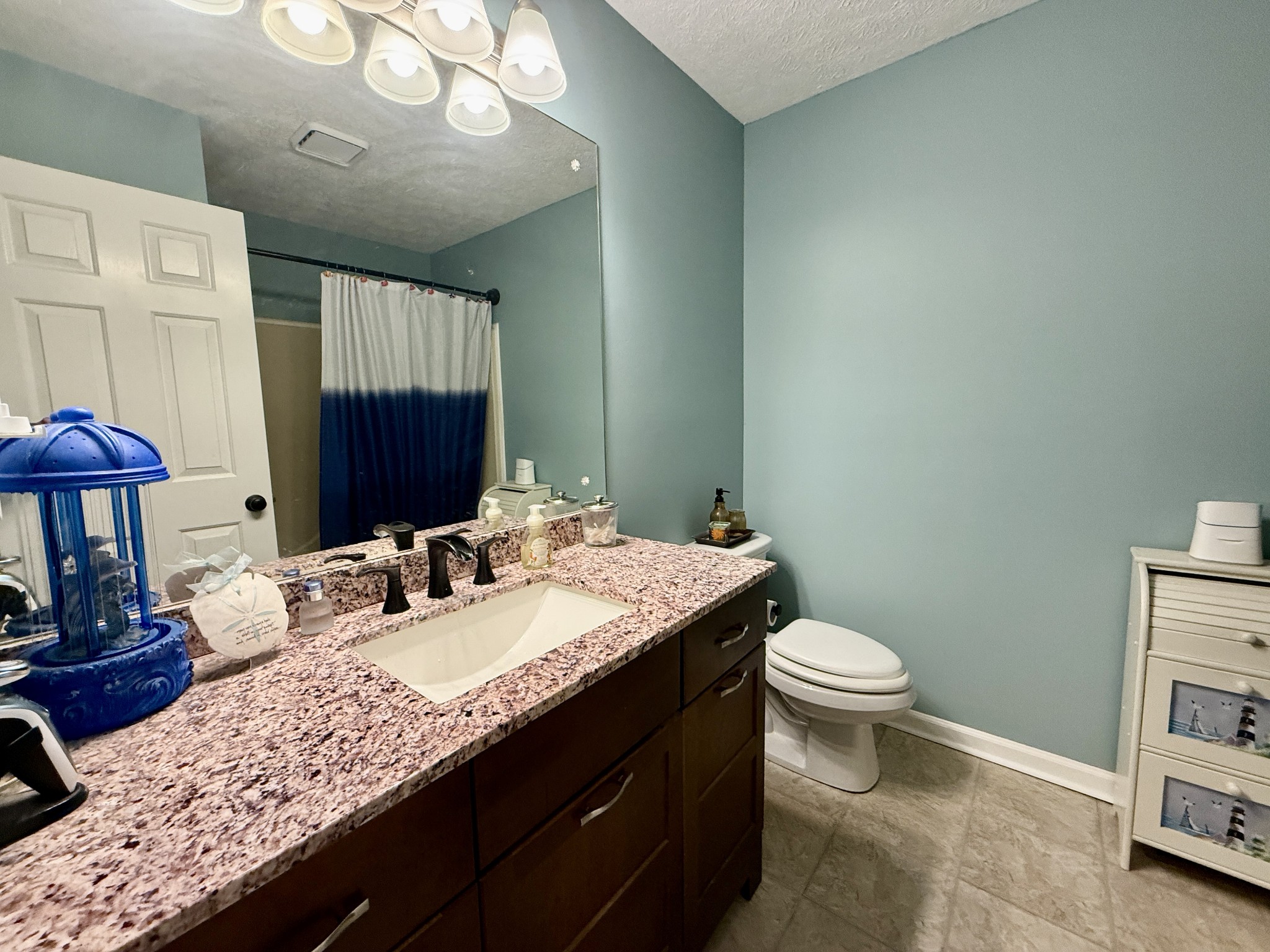 1545 Leeville Road Lebanon, TN 37090 - Photo 8 of 66 a bathroom with a granite countertop sink a toilet and a mirror