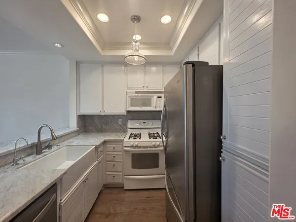 a kitchen with a sink cabinets and stainless steel appliances