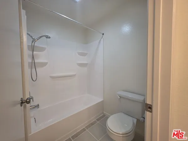 a view of a hallway with wooden shelves