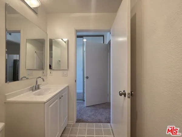 an empty room with a window and a ceiling fan