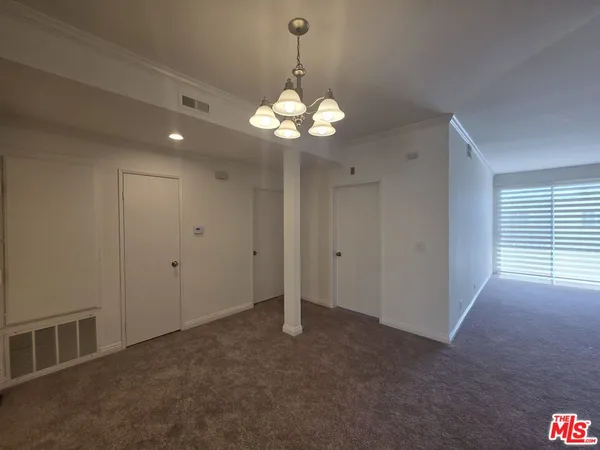 a view of empty room with a fireplace