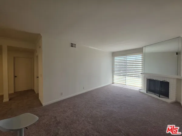 a kitchen with stainless steel appliances kitchen island granite countertop a refrigerator and cabinets