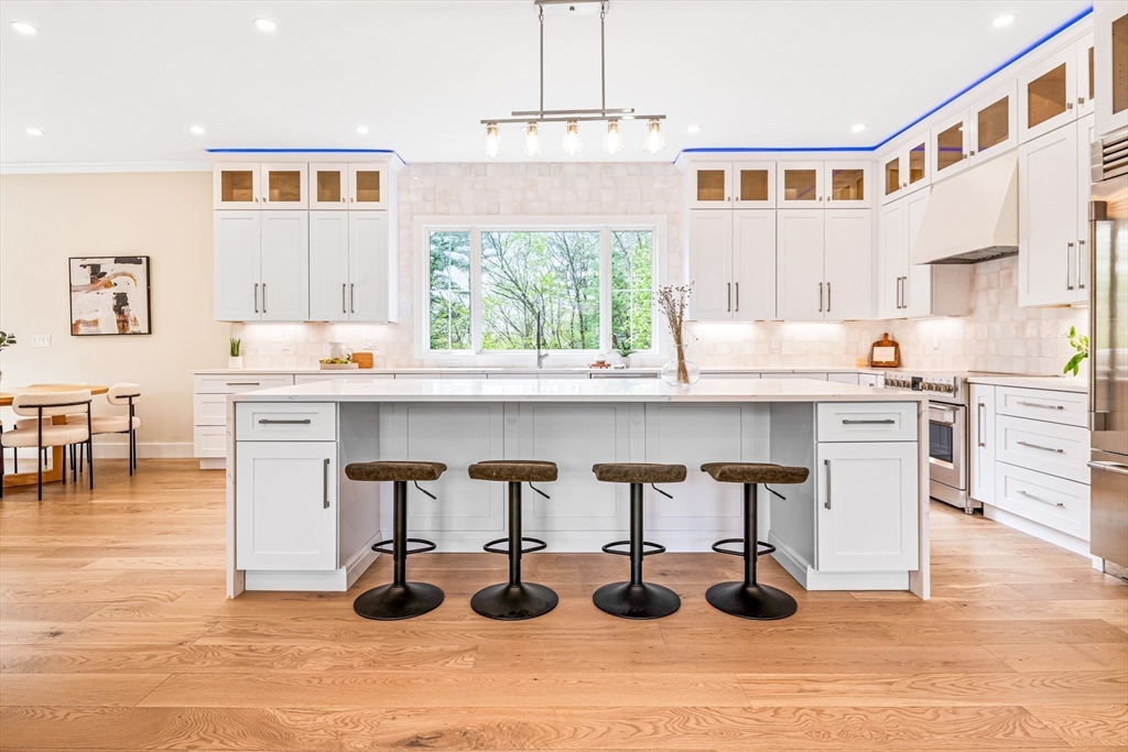 36 Oakmount Circle Lexington, MA 02420 - Photo 14 of 42 a kitchen with stainless steel appliances granite countertop a stove and white cabinets