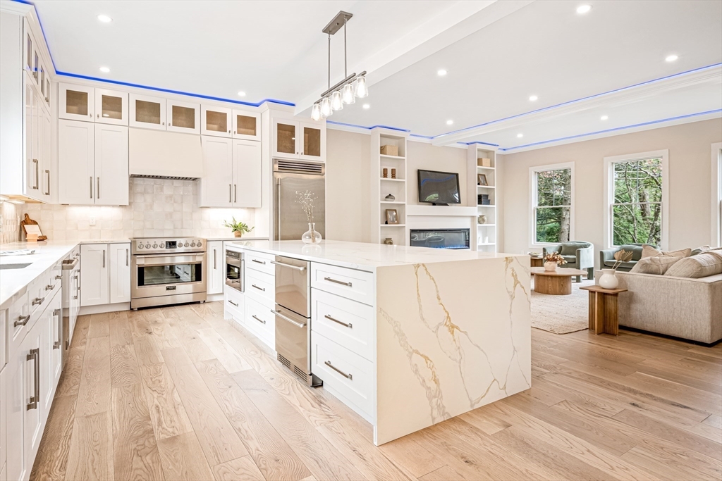 36 Oakmount Circle Lexington, MA 02420 - Photo 15 of 42 a kitchen with stainless steel appliances kitchen island granite countertop a stove and a sink