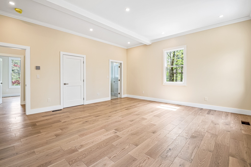 36 Oakmount Circle Lexington, MA 02420 - Photo 21 of 42 a view of an empty room with wooden floor and a window