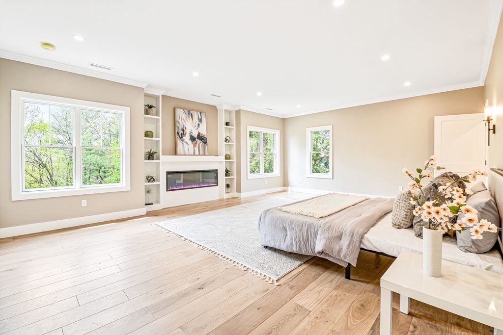 36 Oakmount Circle Lexington, MA 02420 - Photo 26 of 42 a spacious bedroom with a large bed and a chandelier