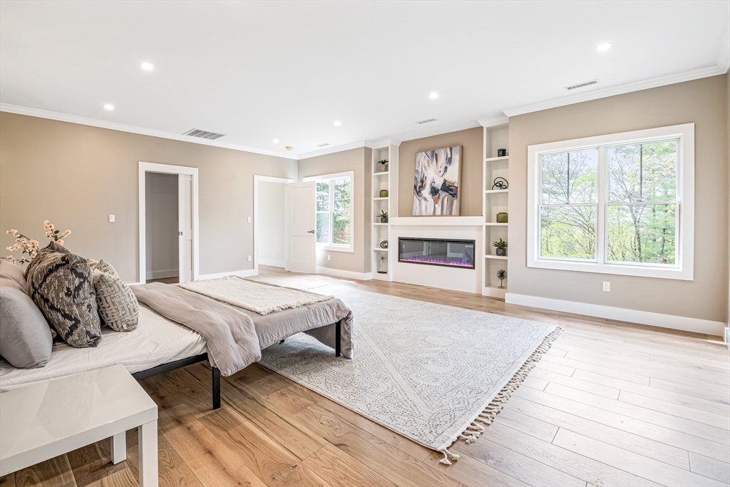 36 Oakmount Circle Lexington, MA 02420 - Photo 28 of 42 a bedroom with furniture and a fireplace