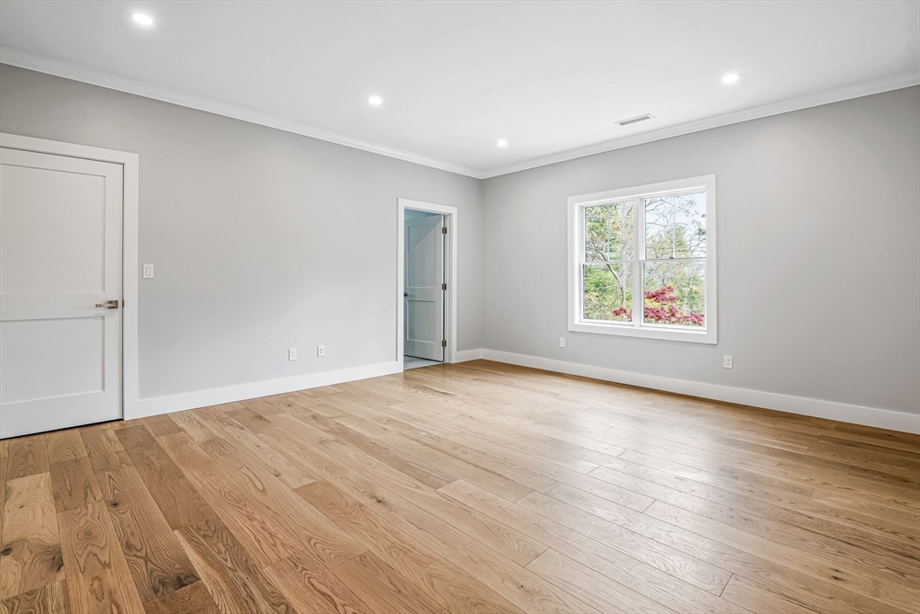 36 Oakmount Circle Lexington, MA 02420 - Photo 36 of 42 an empty room with wooden floor and window
