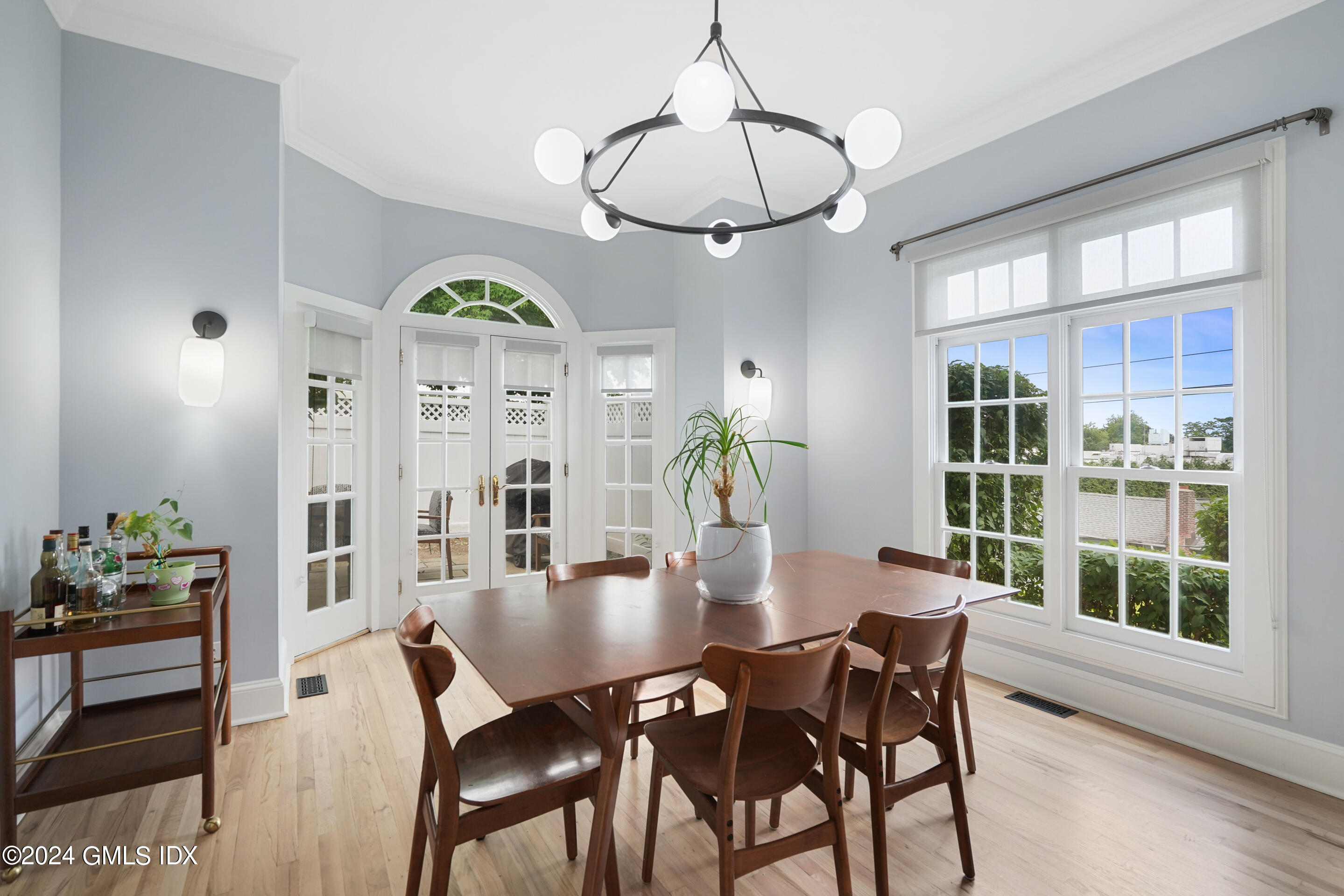 48 Spring Street, Unit 11 Greenwich, CT 06830 - Photo 6 of 24 a view of a dining room with furniture a chandelier and wooden floor