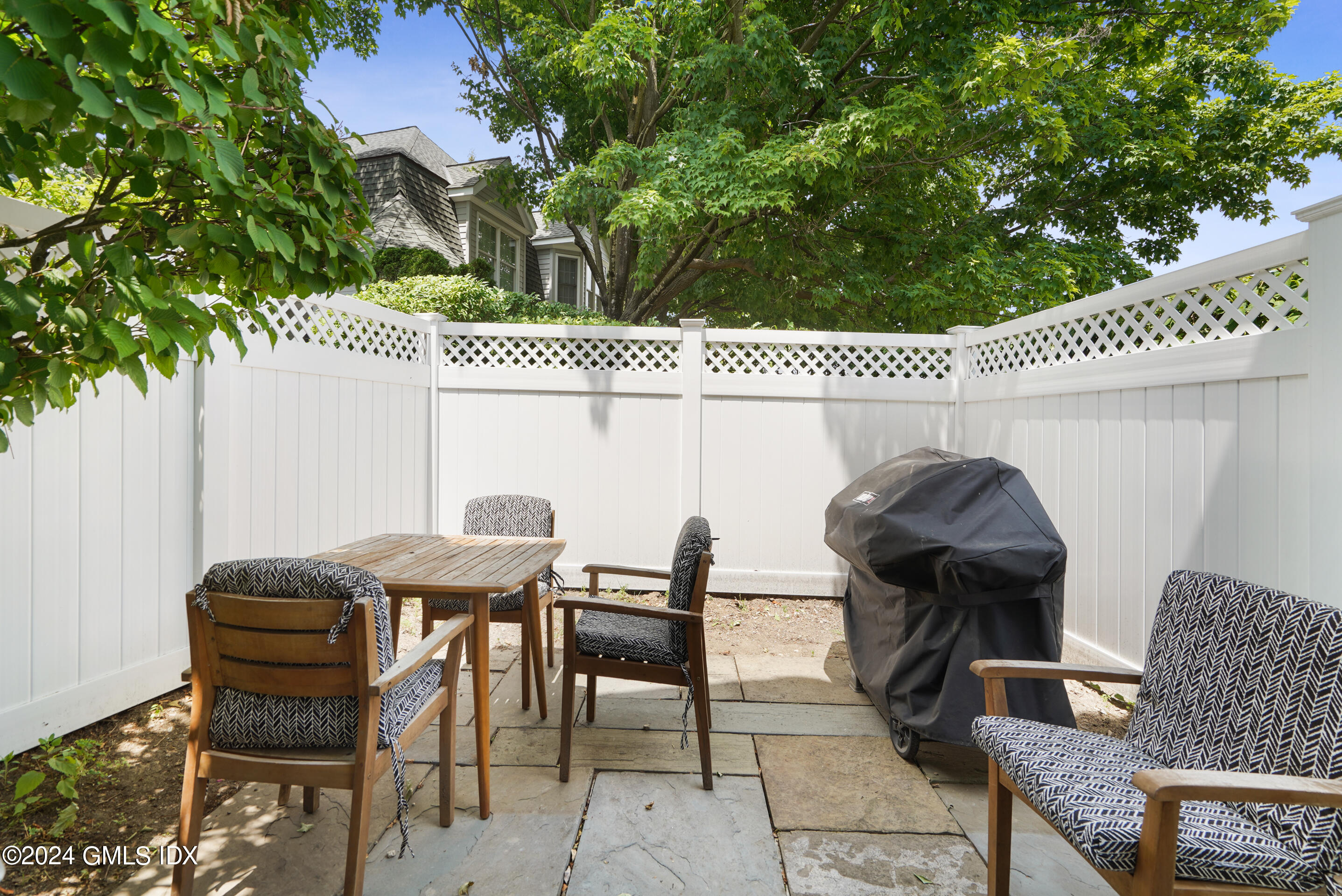 48 Spring Street, Unit 11 Greenwich, CT 06830 - Photo 8 of 24 a patio with table and chairs