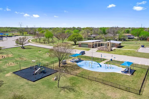 a backyard of a house with lots of green space and fountain