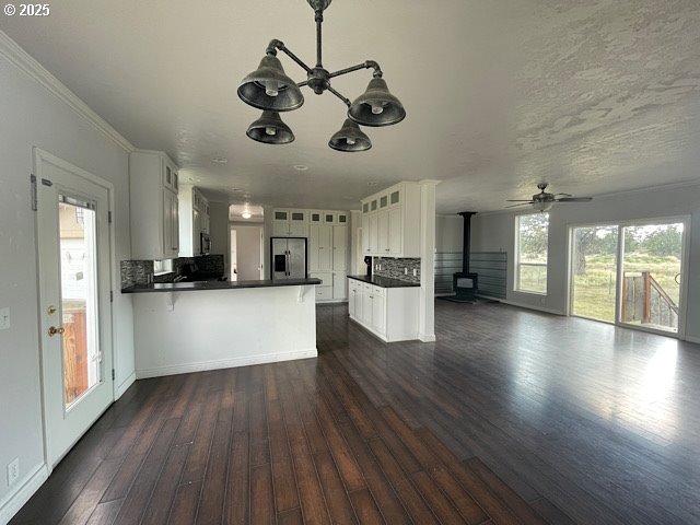 9290 Southwest 3115th Road Culver, OR 97734 - Photo 4 of 21 a view of a kitchen and an empty room with wooden floor