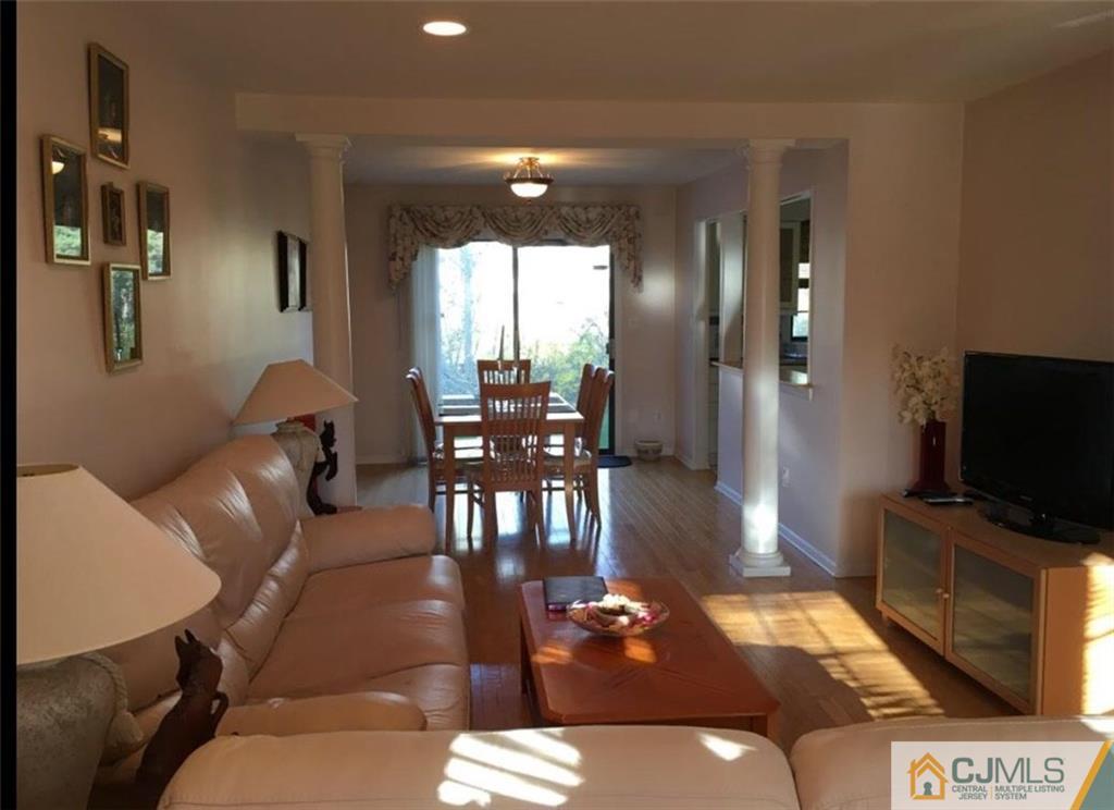 1504 Maplecrest Road Edison, NJ 08820 - Photo 3 of 15 a living room with furniture a dining table and a flat screen tv