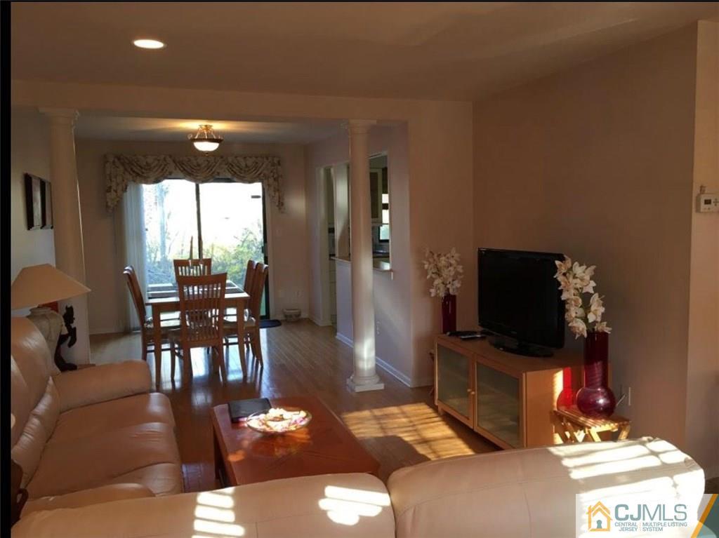1504 Maplecrest Road Edison, NJ 08820 - Photo 4 of 15 a living room with furniture a dining table and a potted plant