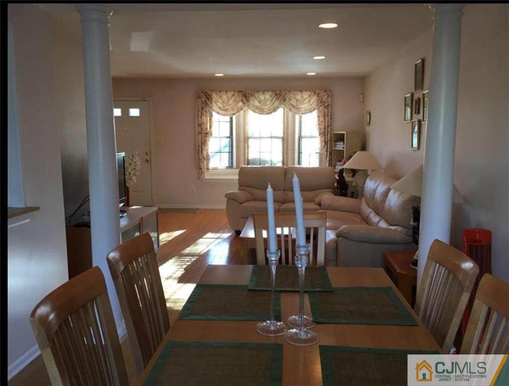 1504 Maplecrest Road Edison, NJ 08820 - Photo 7 of 15 a living room with furniture dining table and a large window