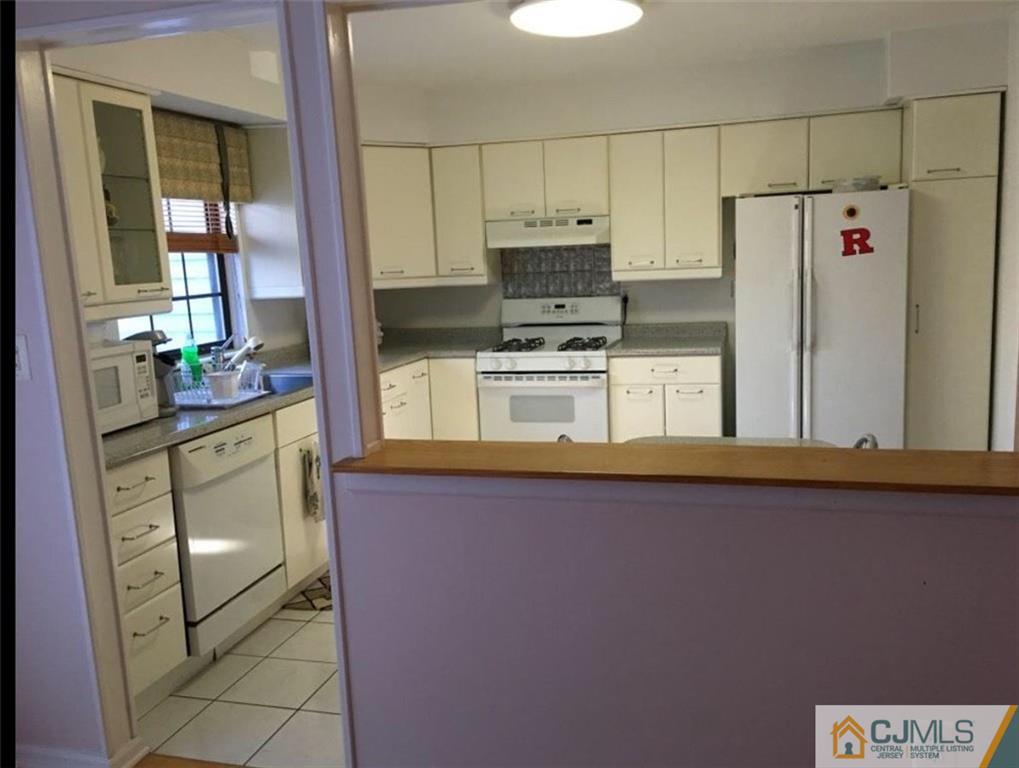 1504 Maplecrest Road Edison, NJ 08820 - Photo 8 of 15 a kitchen with a refrigerator and a stove