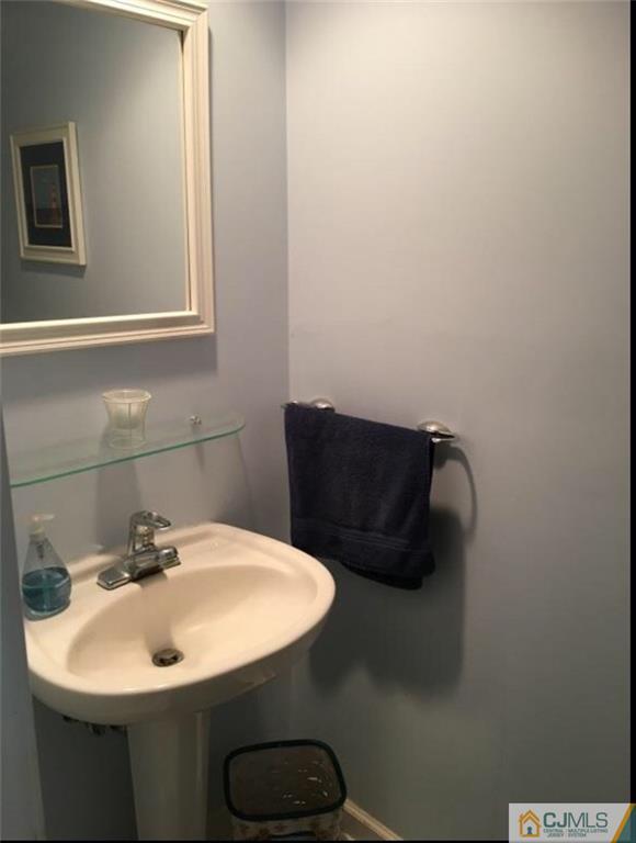 1504 Maplecrest Road Edison, NJ 08820 - Photo 10 of 15 a bathroom with a sink and a mirror