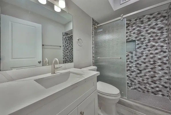a bathroom with a sink toilet and shower