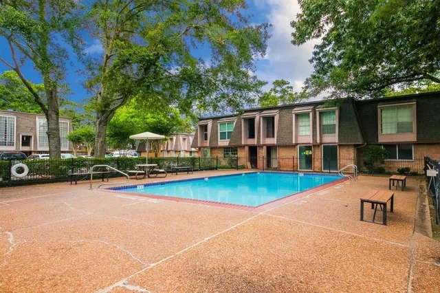 a view of a house with pool porch and chairs