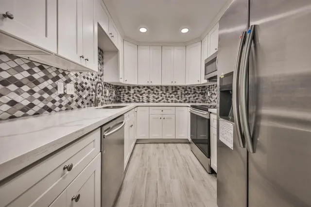 a kitchen with a sink stainless steel appliances and cabinets