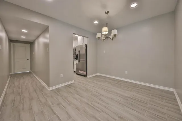 an empty room with wooden floor