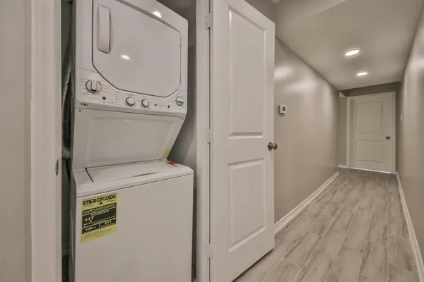 a view of washer and dryer with wooden floor