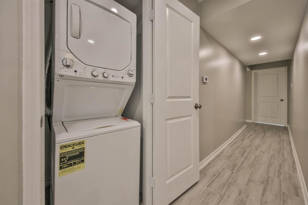 12633 Memorial Drive, Unit 159 Houston, TX 77024 - Photo 4 of 15 a view of washer and dryer with wooden floor