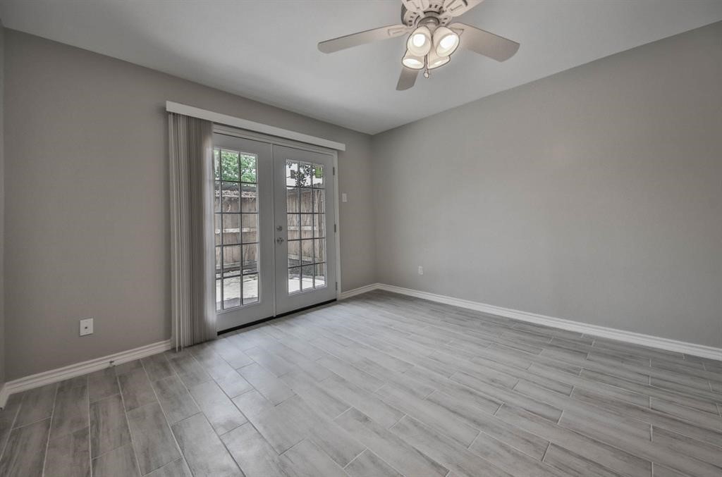 12633 Memorial Drive, Unit 159 Houston, TX 77024 - Photo 5 of 15 a view of an empty room with wooden floor and a window