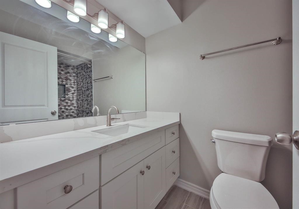 12633 Memorial Drive, Unit 159 Houston, TX 77024 - Photo 7 of 15 a bathroom with a toilet sink and mirror